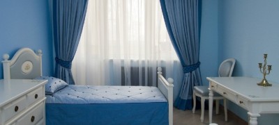 Curtains under blue wallpaper