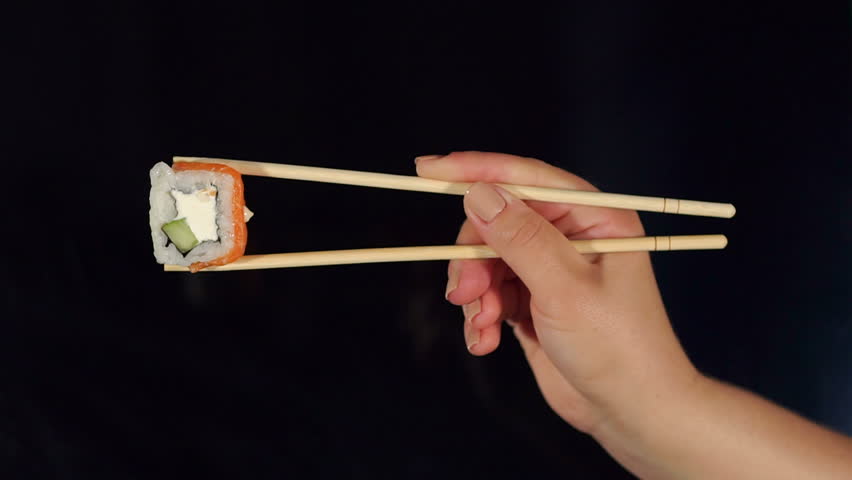 how to hold sushi sticks