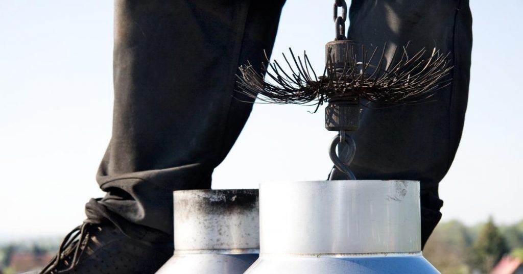 cleaning the chimney with a brush