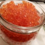 glass jar with red caviar photo