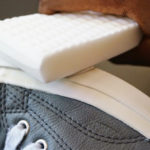 cleaning the sole of sneakers with a melamine sponge