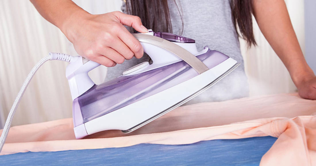 ironing a woman's shirt photo