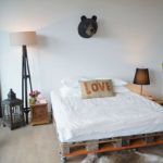 pallet bed with a bear upstairs