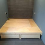 podium bed with blue walls