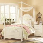 canopy bed with striped bedspread