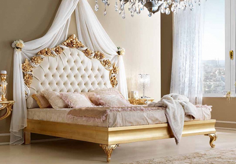 bed with a soft headboard and a canopy