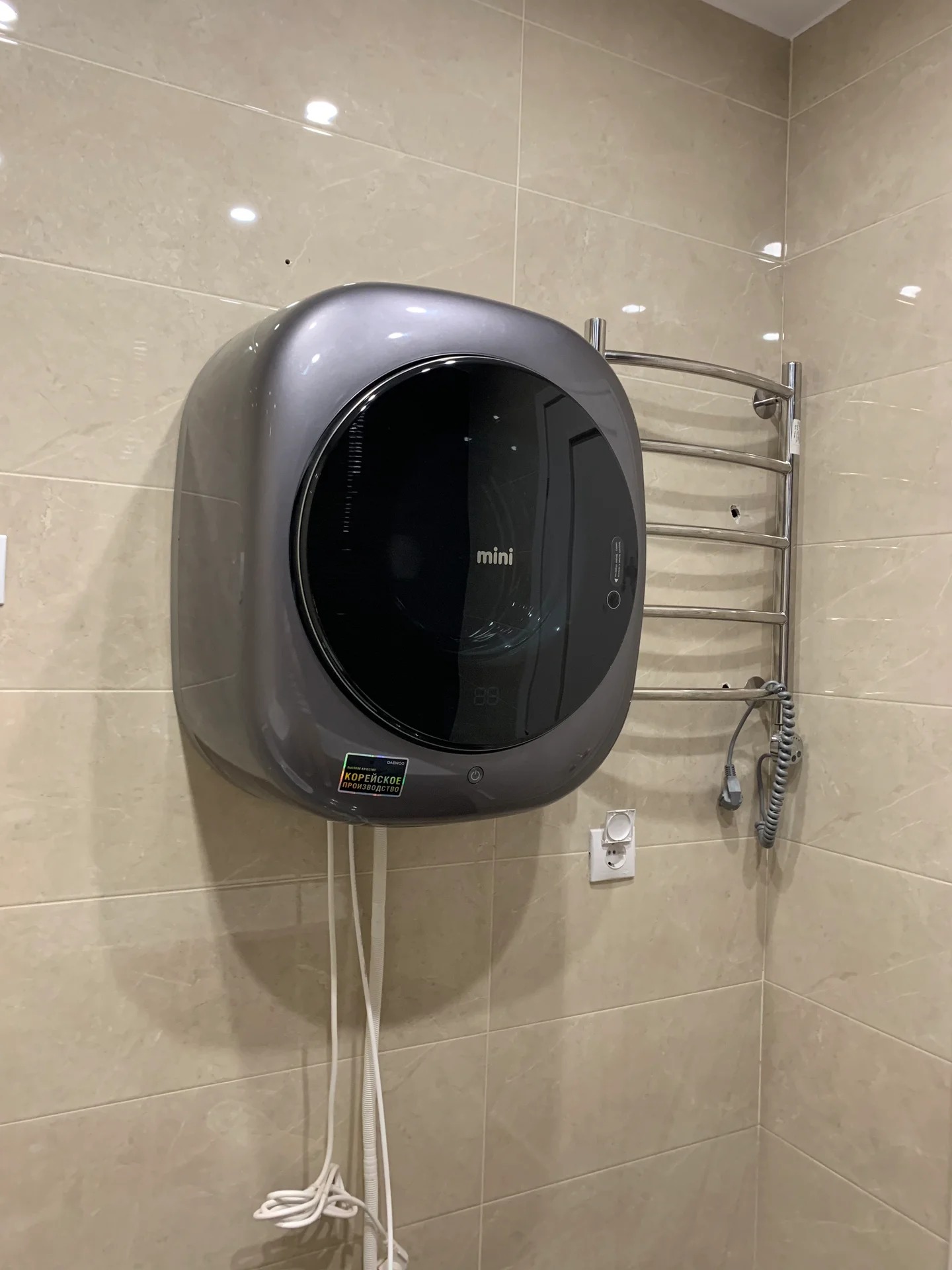 wall-mounted washing machine in the bathroom interior