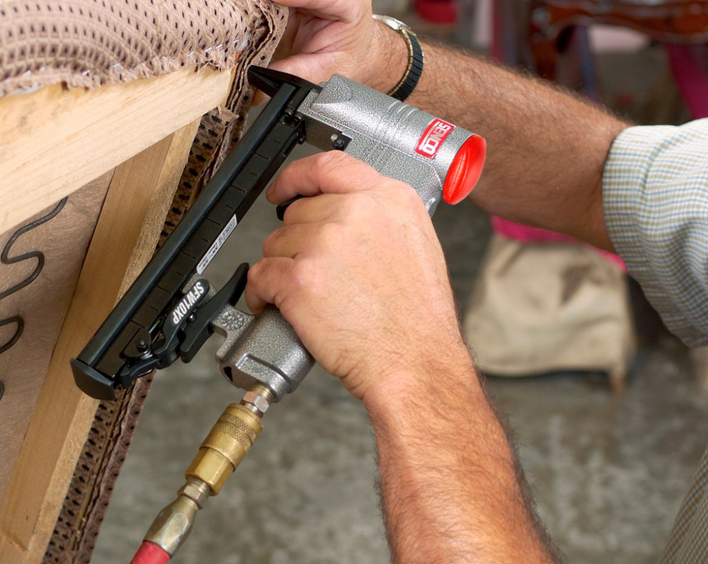 fixing the material with staples when upholstery