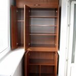 brown wardrobe with shelves on the balcony