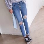 asymmetrical holes on jeans