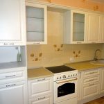 white kitchen set with yellow tiles