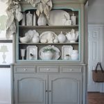 gray sideboard with dishes