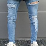 jeans with holes and white thread