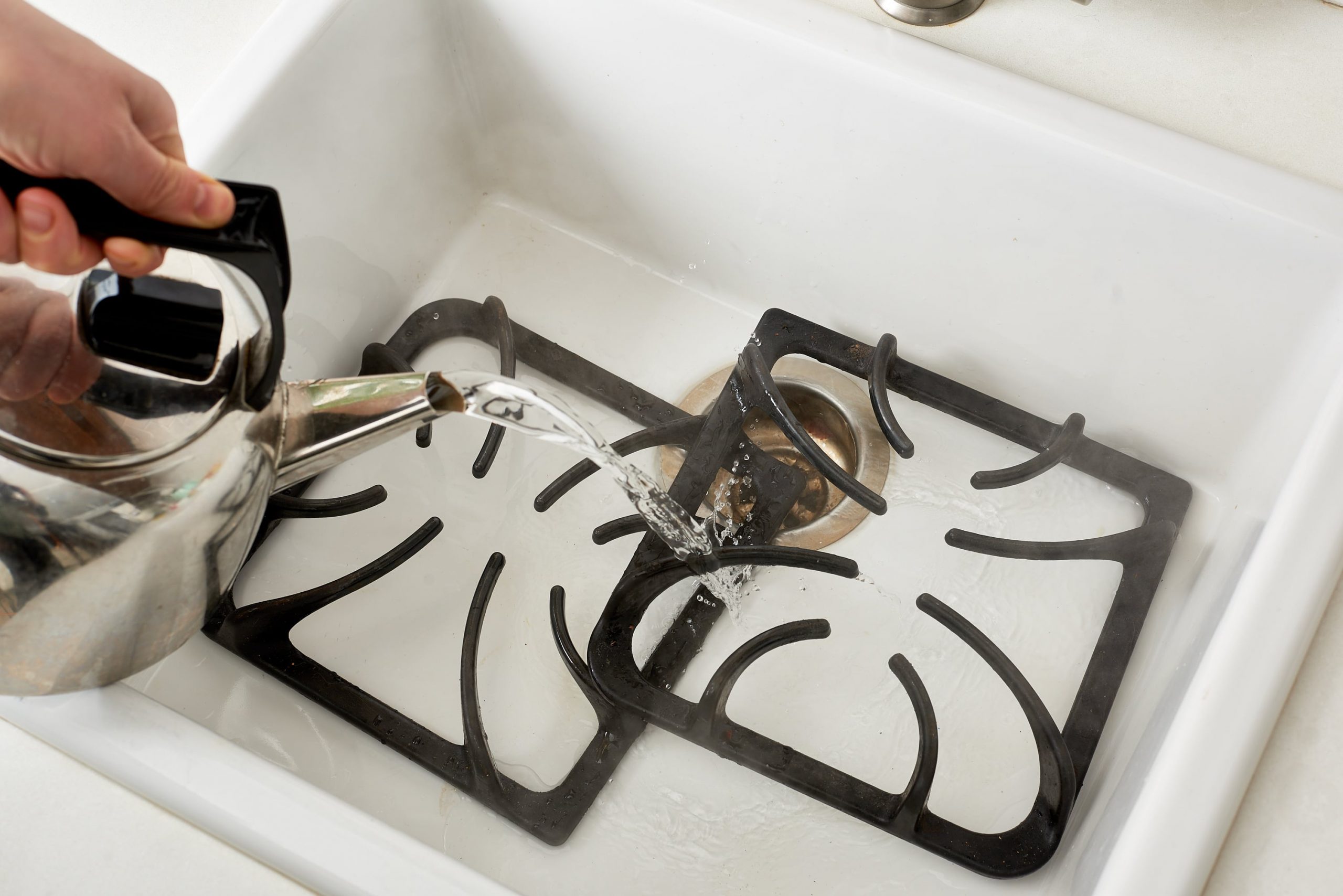 cleaning the grate with boiling water