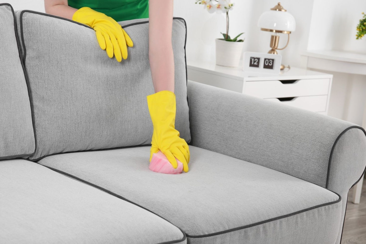 cleaning the sofa with gloves