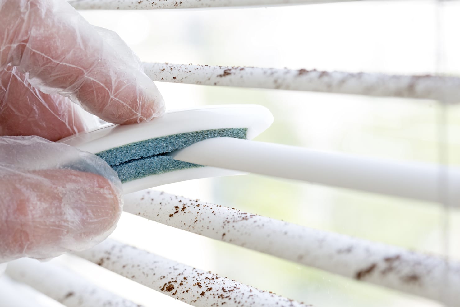 cleaning blinds with a brush