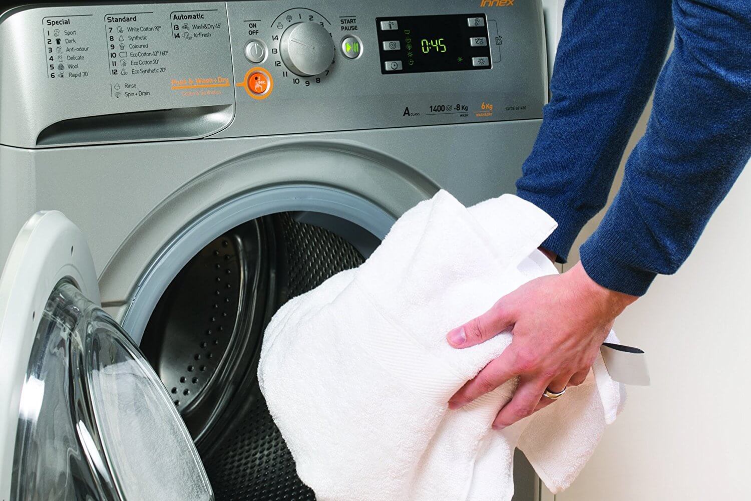 loading clothes into the washing machine