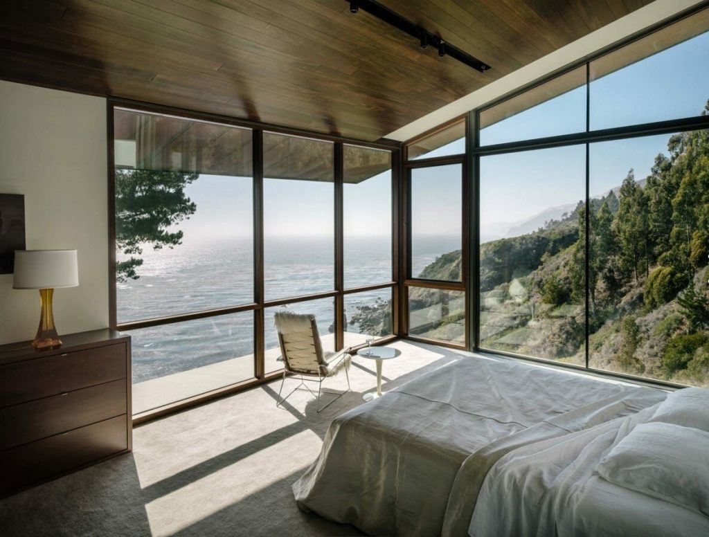 bed in a room with a panoramic view