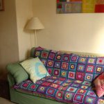 knitted blanket in squares on the sofa