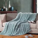 turquoise knitted bedspread on the sofa