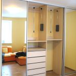 built-in wardrobe with orange sofa