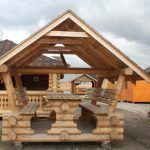 gazebo with a table from a log house