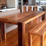 table in the kitchen with a bench