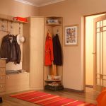 corner wardrobe in the hallway with orange carpet