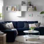 multi-tiered shelf above the sofa with books