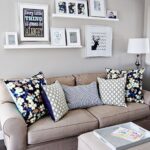 shelf and paintings above the sofa