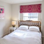 bed by the window in the bedroom overview