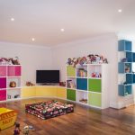 table along the window in the nursery with a TV