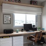 table along the window in the nursery with an armchair