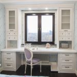 table along the window in the nursery white wardrobes