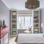 table along the window in the nursery with wardrobes