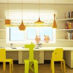 table along the window in the nursery yellow chairs