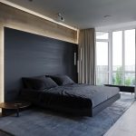 rectangular light bedroom with a dark bed