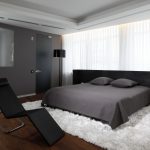 dark furniture in the bedroom with a large window