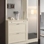 mirror in the hallway with a chest of drawers