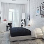 white bedroom with brick wall