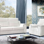 white leather sofa with blue curtain