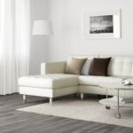 white leather sofa with beige cushions