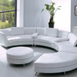 white leather semicircular sofa with plant