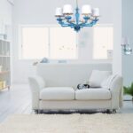 white leather sofa with chandelier