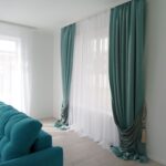 turquoise curtains on a large window