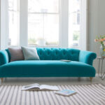 turquoise sofa with two pillows