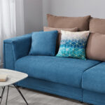 turquoise sofa with beige pillows