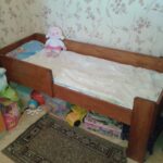 children's bed made of wood with dolls