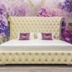 bed with headboard with purple pillows