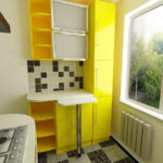 small yellow kitchen with bar counter